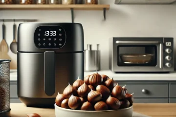 Freidora de aire moderna en una cocina con un bol de castañas en la encimera y un microondas en el fondo.